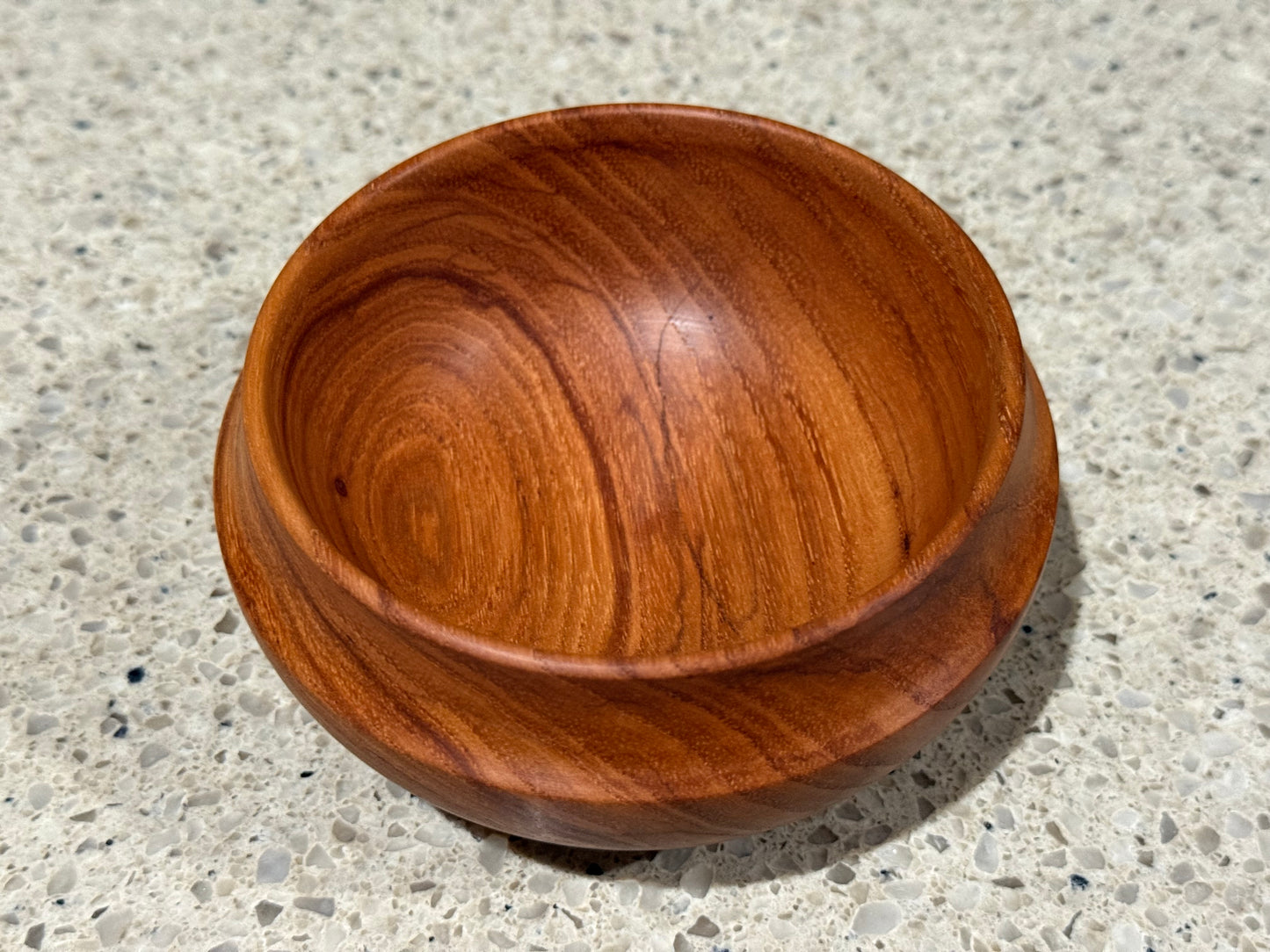 Wooden bowl on a concrete surface