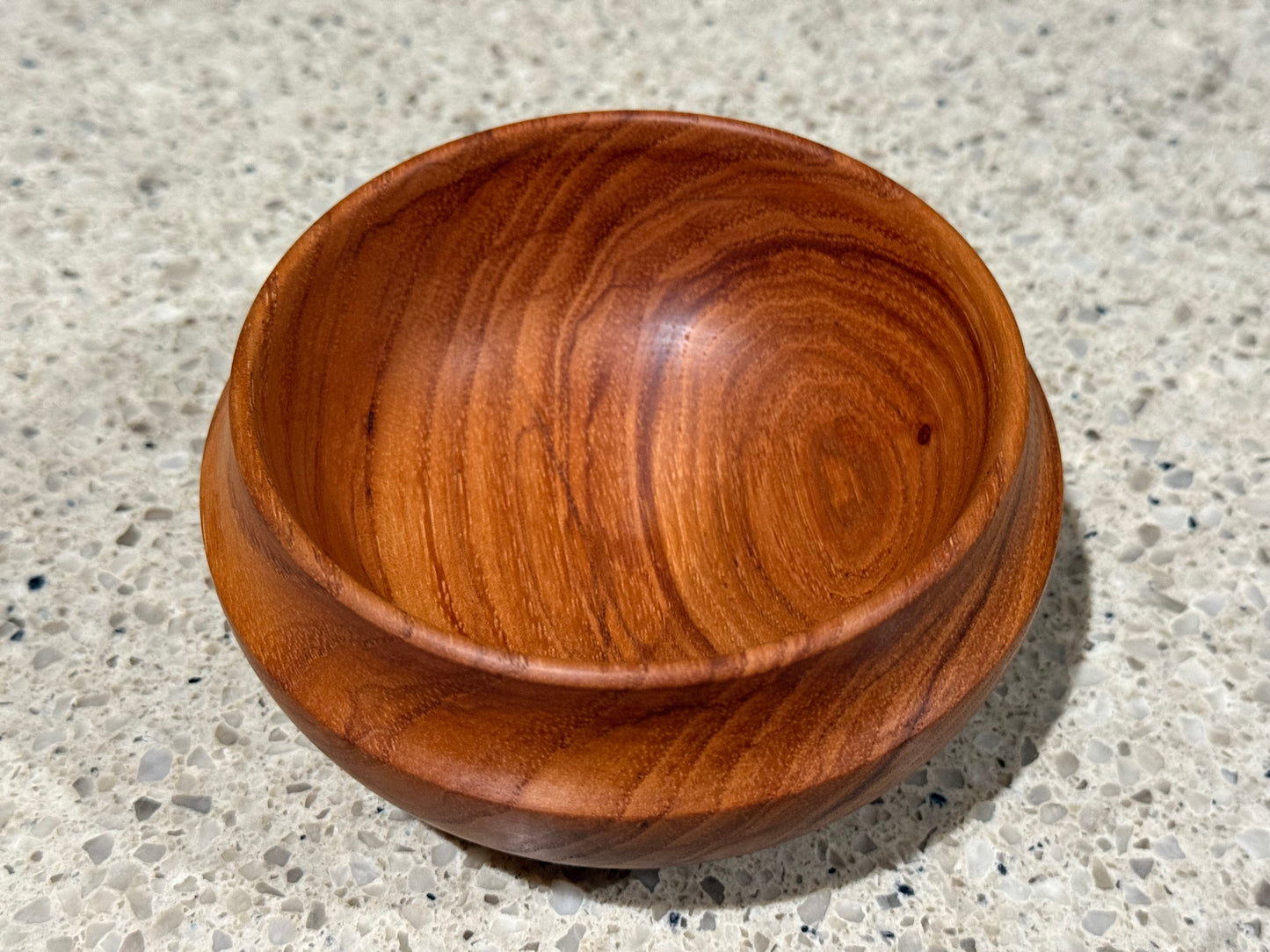 Wooden bowl on a concrete surface
