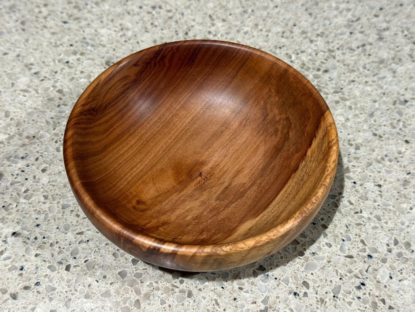 Wooden bowl on a concrete surface