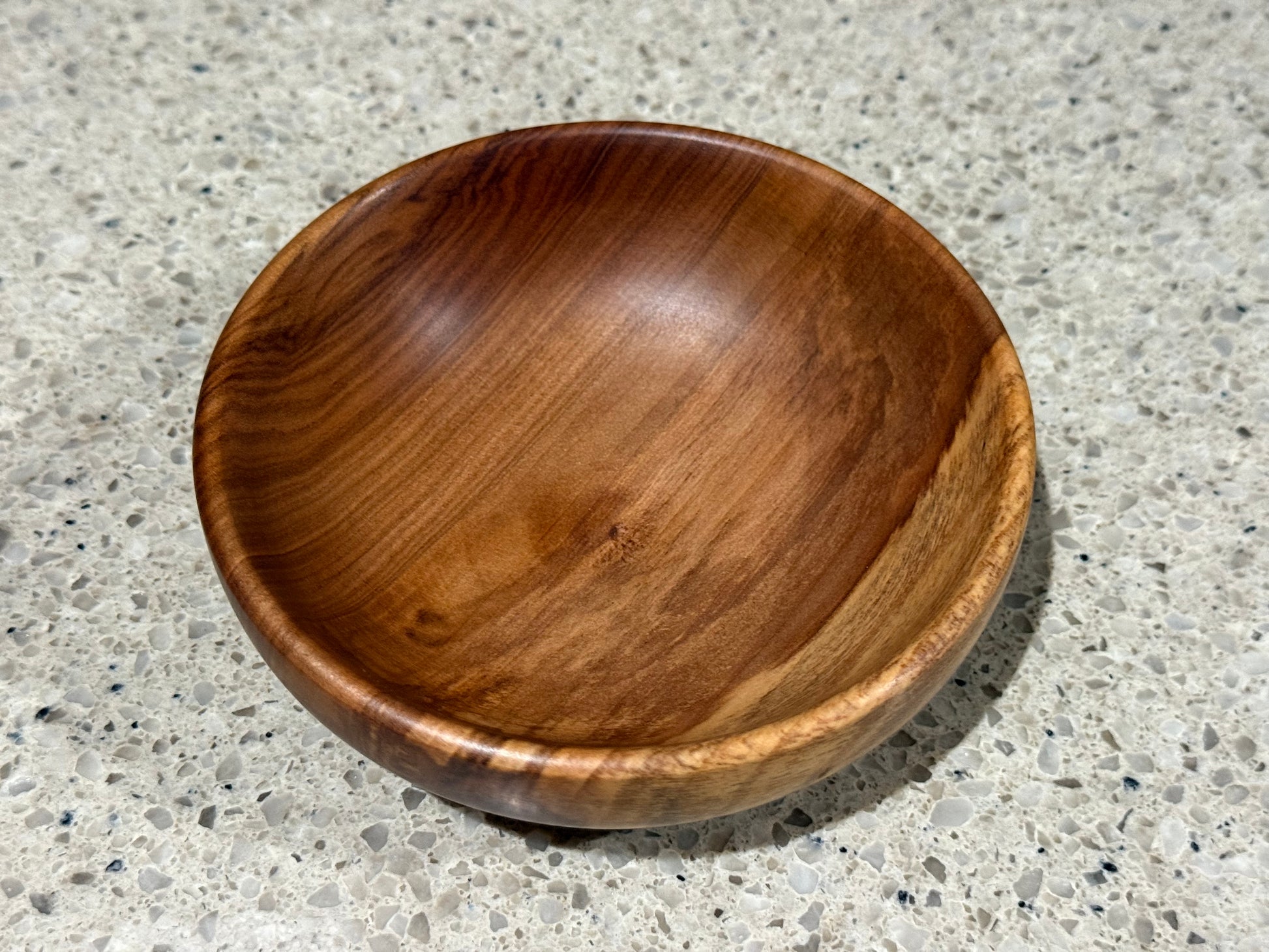 Wooden bowl on a concrete surface