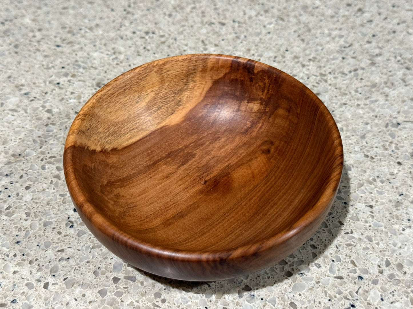 Wooden bowl on a concrete surface