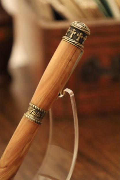 Wooden pen with metal rings and a blurred background. Faith Hope and Love