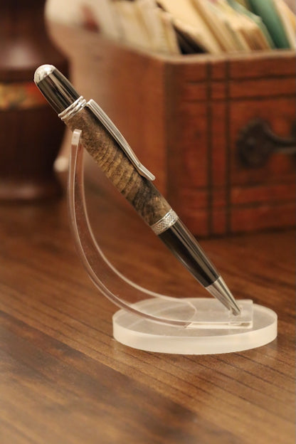 custom Pen on a clear stand with a wooden and metal design, placed on a wooden surface.