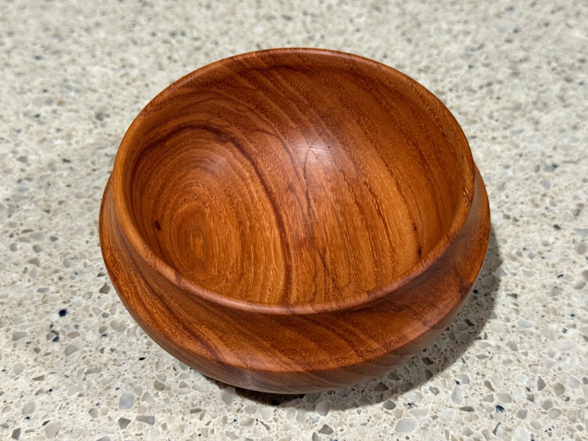 Wooden bowl on a concrete surface